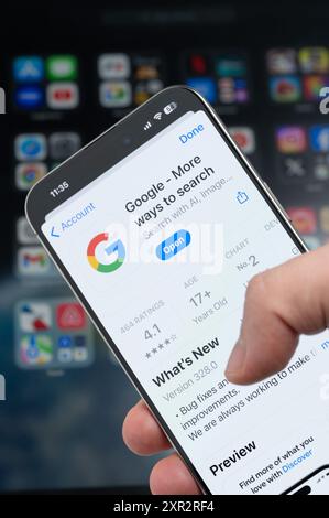 New York, USA - August 5, 2024: Smartphone in hand with Google app on screen macro close up view with blur background Stock Photo