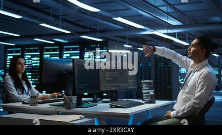 Admin in data center using augmented reality technology to ensure system can handle networking tasks. Server room worker looking at AR visualization hologram, tracking network traffic, camera B Stock Photo