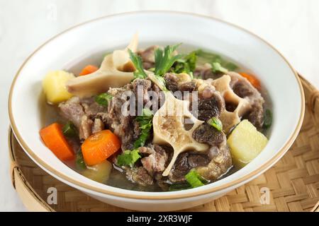 Close Up Indonesian Oxtail Clear Soup or Sop Buntut with Potato and Carrot Stock Photo