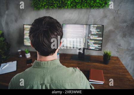 Rear view back side photo of man hardware expert work with modern technology operating system workspace indoors Stock Photo