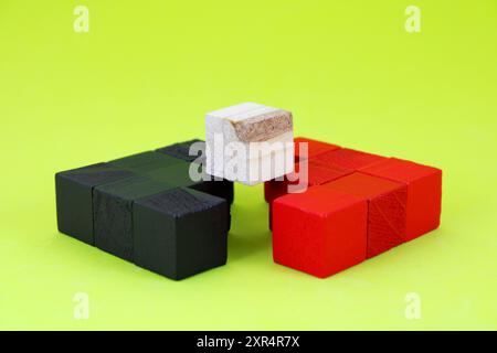 Wooden cube on arrows pointing in opposite directions Stock Photo