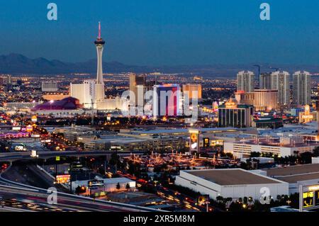 Dusk sets on the Las Vegas desert and  and the lights go up on the casino hotels along the Strip, including the Stratosphere, Stardust and Frontier Ho Stock Photo