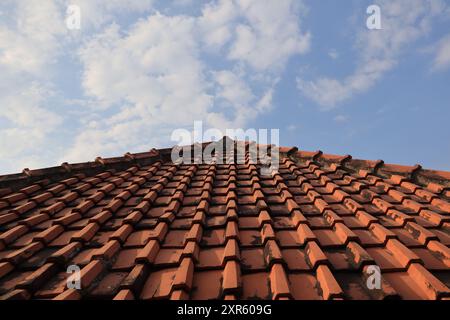 House roof tiles with cloudy sky background Stock Photo