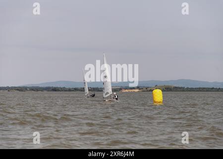 Golubac, Serbia, June 9, 2024: Sailing boats jostle for position in a Laser-Class sailing regatta on the Danube River. Stock Photo