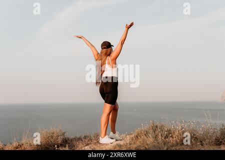 Woman Celebrating on a Clifftop Stock Photo