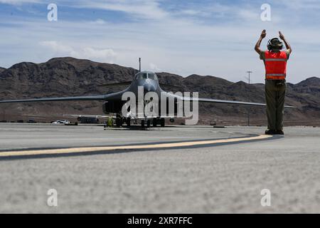 U.S. Air Force Senior Airman Peyton Ung, 28th Maintenance Group crew chief, marshals a B-1B Lancer during Bamboo Eagle 24-3 at Nellis Air Force Base, Stock Photo