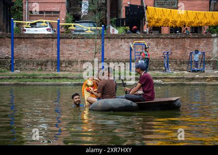 Bhaktapur, Bagmati, Nepal. 9th Aug, 2024. Locals of Bhaktapur worship the idol of serpent deity(snake) during Nag Panchami Festival. People on this day stick the poster of serpent deity(snake) on the main door step of the house, clean nearest local pond and worship snake gods, also called the Nagas during Nag Panchami. (Credit Image: © Amit Machamasi/ZUMA Press Wire) EDITORIAL USAGE ONLY! Not for Commercial USAGE! Credit: ZUMA Press, Inc./Alamy Live News Stock Photo