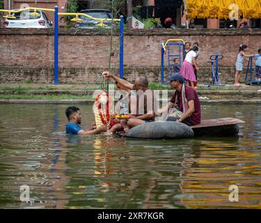 Bhaktapur, Bagmati, Nepal. 9th Aug, 2024. Locals of Bhaktapur worship the idol of serpent deity(snake) during Nag Panchami Festival. People on this day stick the poster of serpent deity(snake) on the main door step of the house, clean nearest local pond and worship snake gods, also called the Nagas during Nag Panchami. (Credit Image: © Amit Machamasi/ZUMA Press Wire) EDITORIAL USAGE ONLY! Not for Commercial USAGE! Credit: ZUMA Press, Inc./Alamy Live News Stock Photo