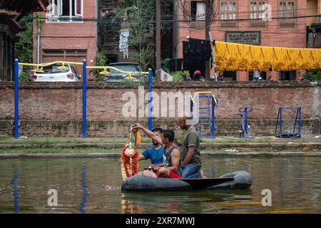 Bhaktapur, Bagmati, Nepal. 9th Aug, 2024. Locals of Bhaktapur worship the idol of serpent deity(snake) during Nag Panchami Festival. People on this day stick the poster of serpent deity(snake) on the main door step of the house, clean nearest local pond and worship snake gods, also called the Nagas during Nag Panchami. (Credit Image: © Amit Machamasi/ZUMA Press Wire) EDITORIAL USAGE ONLY! Not for Commercial USAGE! Credit: ZUMA Press, Inc./Alamy Live News Stock Photo