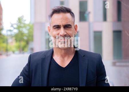 portrait of smiling businessman looking at camera outdoors Stock Photo