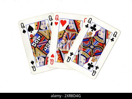 Vintage playing cards showing three queens on a white background. Stock Photo