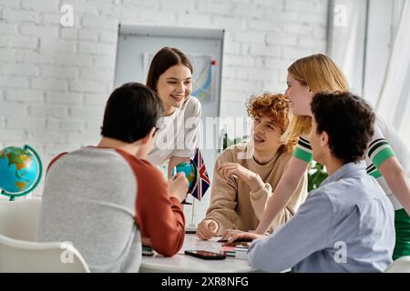 Teenagers gather around a table, engaged in a lively discussion during a UN Model conference. Stock Photo