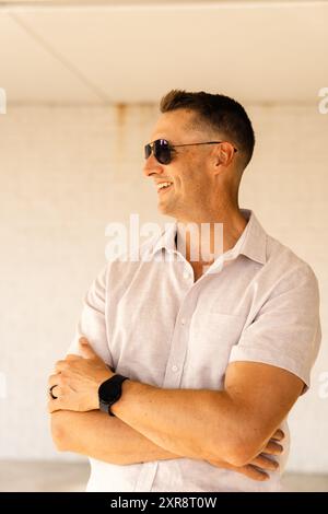 Smiling man looking away wearing sunglasses Stock Photo