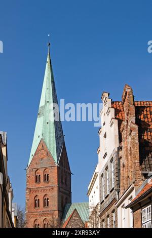 Tower of St. Aegidien Church in the old town of Lübeck, Germany, rising next to the gables of old houses Stock Photo