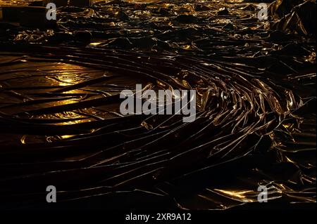 Plastic material being highlighted by yellow lamps Stock Photo