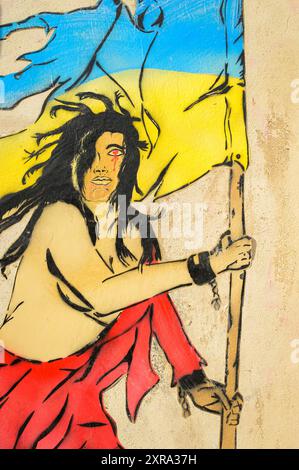 Arles, France - March 1, 2023: Colorful painting on the facade of a house, person with ukrainian flag Stock Photo