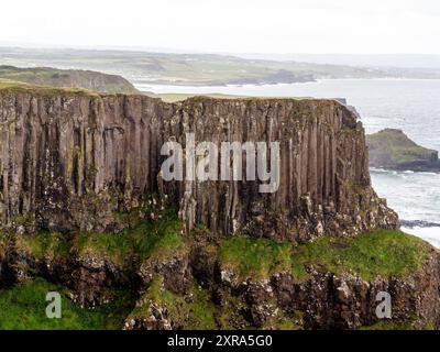 A view of a cliff formed by basalt stone columns known as 'Giant’s Organ'. The Giant’s Causeway and Causeway Coast is an area of global geological importance on the sea coast of Northern Ireland. The 40,000 basalt stone columns left by volcanic eruptions 60 million years ago have attracted millions of tourists over the years.The Giant’s Causeway is the most popular visitor attraction in all of Ireland, North or South. Stock Photo