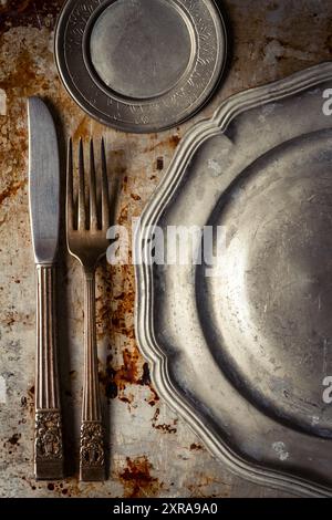 Kitchen utensils on dirty oven baking tray at kitchen, aluminum old baking sheet, top view. Grunge Background. Stock Photo