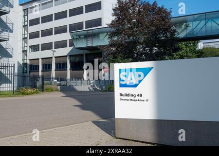 SAP SE logo prominently displayed on modern corporate headquarters facade, SAP corporate campus, symbolizing global software industry leadership, Wall Stock Photo
