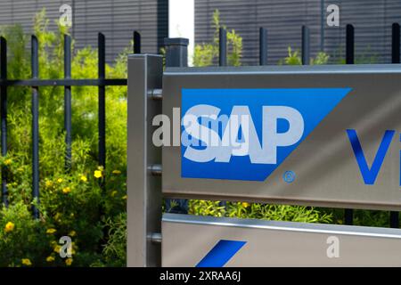 SAP SE logo prominently displayed on modern corporate headquarters facade, SAP corporate campus, symbolizing global software industry leadership, Wall Stock Photo