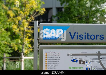 SAP SE logo prominently displayed on modern corporate headquarters facade, SAP corporate campus, symbolizing global software industry leadership, Wall Stock Photo