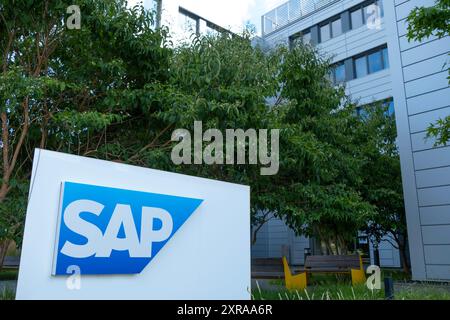 SAP SE logo prominently displayed on modern corporate headquarters facade, SAP corporate campus, symbolizing global software industry leadership, Wall Stock Photo