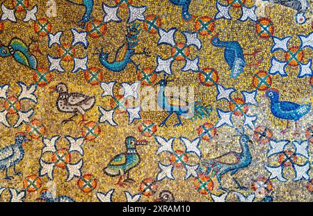 Close-up on colorful wall mosaic showing different kinds of birds amidst flowers Stock Photo