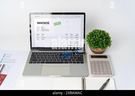 Close-up difference invoices and bills, document and paperwork. Digital Tax E Invoice Online Software On Laptop Screen. Online Electronic Bill Managem Stock Photo
