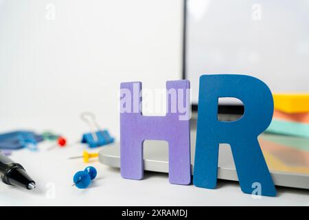 Color cloth alphabet letter in word HR (Abbreviation of human resource) on wood background. Wooden blocks with letters, human resources new employees Stock Photo