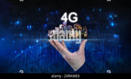 Creative background, male hand holding a phone with 4G hologram on city background. Concept of 4G network, mobile high speed internet, new generation Stock Photo