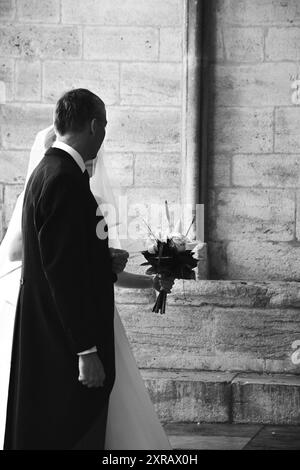 Wedding day.  Father taking  daughter to altar. Black and white. Stock Photo