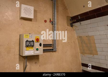 An electrical switch / Junction box on the wall of a disused tunnel in Holborn Tube station Stock Photo