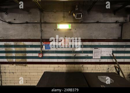 A CCTV security camera on a disused tunnel wall in Holborn Tube Station Stock Photo