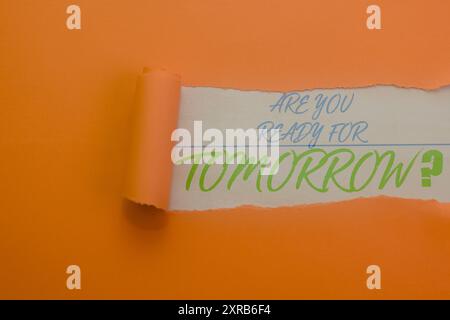 Orange paper ripped open to reveal the question: "Are you ready for tomorrow?" Perfect for planning, future, or motivational themes. Stock Photo