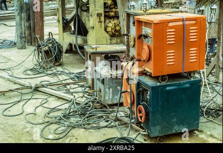 The image is of electric arc welding machines on a construction site wired up to a  electrical distribution system typical to those sites making use of Chinese manufactured knife blade circuit breakers with the fusing device removed making the installation susceptible to fire from overloading Stock Photo