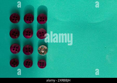 Buttons laid out in a row on a turquoise background. In the style of flat lay. Stock Photo