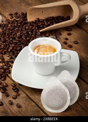 Coffee cups with pods on rustic table Stock Photo