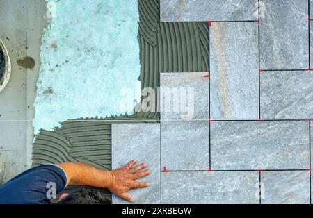 Top view of a tiler working in a garden. Stock Photo