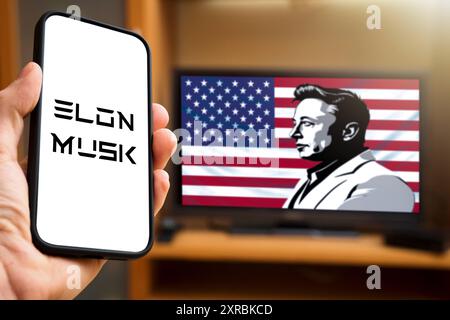 9 August 2024: Smartphone shows the name Elon Musk, while a stylized image of Musk in front of a US flag can be seen in the background. Symbolic image of Musk s significant influence on technology and business in the USA. PHOTOMONTAGE *** Smartphone zeigt den Namen Elon Musk, während im Hintergrund eine stilisierte Darstellung von Musk vor einer US-Flagge zu sehen ist. Symbolbild Musks bedeutenden Einfluss auf Technologie und Wirtschaft in den USA. FOTOMONTAGE Stock Photo