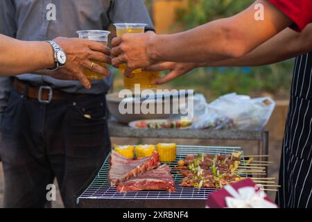 Beer drinks prepared for barbecue party among friends are served in plastic glasses because plastic glasses can be easily stored at end of party. Easy Stock Photo