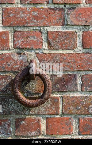 Old rusted ring in a stone wall, close-up Stock Photo