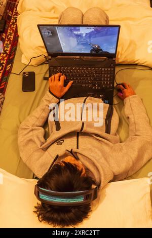 England, London, Teenage Boy Playing Computer Games Stock Photo