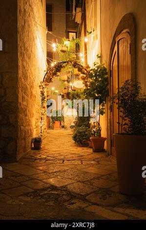 View of a romantically lit alleyway in the old town of Polignano a mare in Apulia Stock Photo