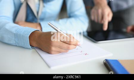 Businessmen make up a strategy, write down a list of options Stock Photo