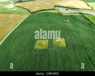 Ancient burial mounds in a farmer's field in Jutland, northern Denmark, aerial drone view Stock Photo