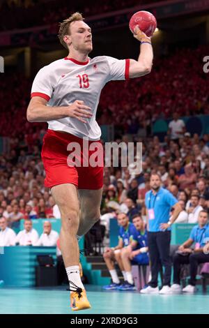 Lille, France. 9th Aug, 2024. Mathias Gidsel of Denmark shoots during the men's semifinal of handball between Slovenia and Denmark at the Paris 2024 Olympic Games in Lille, France, on Aug. 9, 2024. Credit: Meng Dingbo/Xinhua/Alamy Live News Stock Photo