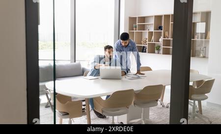 Two diverse businessmen working on online project together Stock Photo