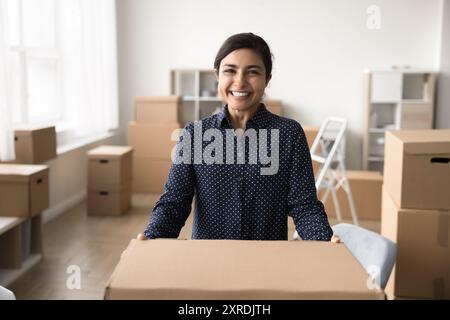 Portrait of successful small business owner holding big carton box Stock Photo