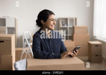 Warehouse worker or small business owner using smartphone Stock Photo