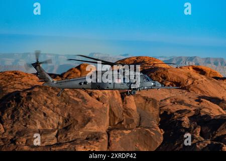 An HH-60W Jolly Green II flies over the Valley of Fire as part of a 53rd Wing Civic Leader flight from Nellis Air Force Base, Nevada, Dec. 12, 2023. T Stock Photo